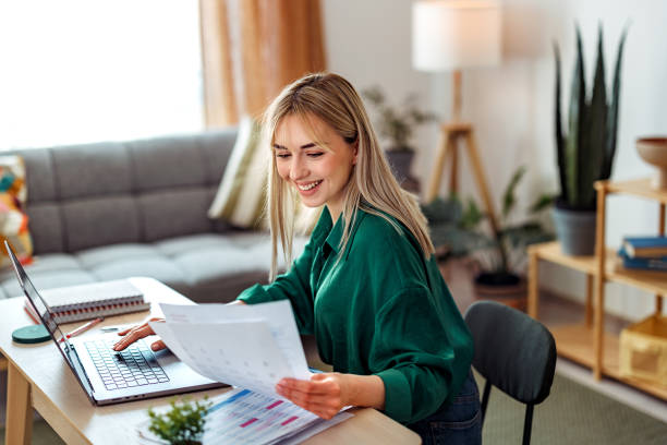 istock Smiling beautiful well dressed young woman working at home office 2148439668