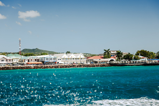 Charlestown, St Kitts and Nevis - March 28, 2028: Buildings and beaches along the shores outside of the port town of Charlestown in Saint Kitts and Nevis