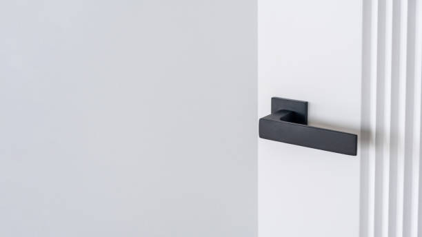 istock Modern black door handle on white wooden door in interior. 2148441355