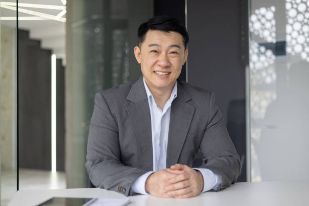 istock Smiling Asian businessman in office setting at work 2148441547