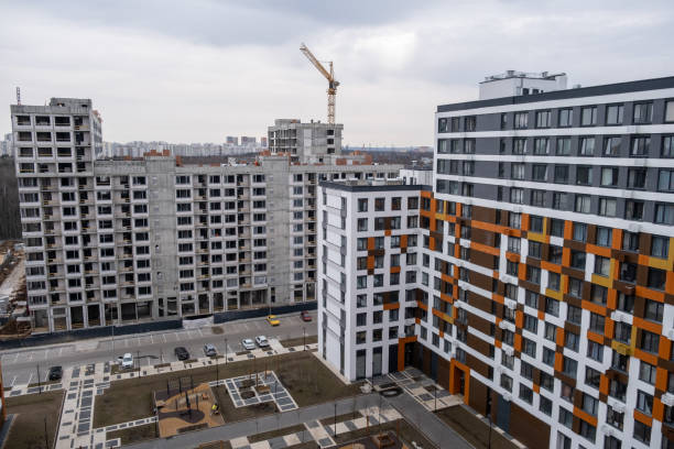 istock crane and a building under construction against a blue sky background 2148441564