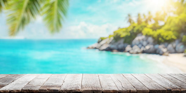 istock Empty wooden table or pier with sunny beach and sea 2148441630