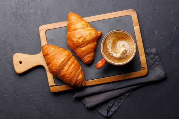 istock Cappuccino coffee and fresh croissants 2148442132