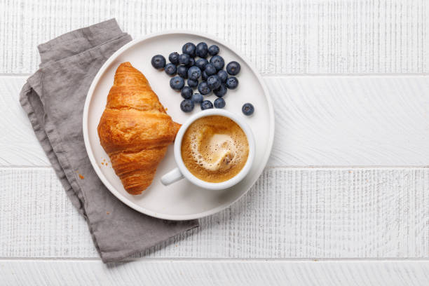 istock Cappuccino coffee and fresh croissant 2148442202