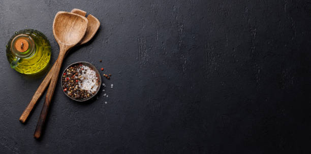 istock Spices, olive oil, and utensils on cooking table 2148442501