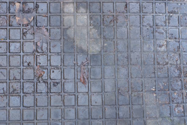 black plastic texture from a piece of an old rubber dirty mat with a square pattern