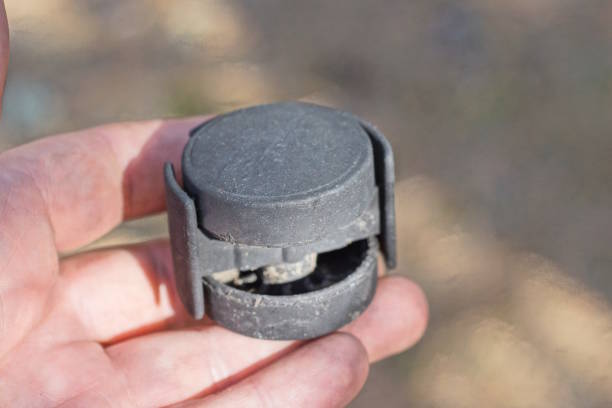 istock hand holds one small black plastic wheel for a luggage bag 2148442684
