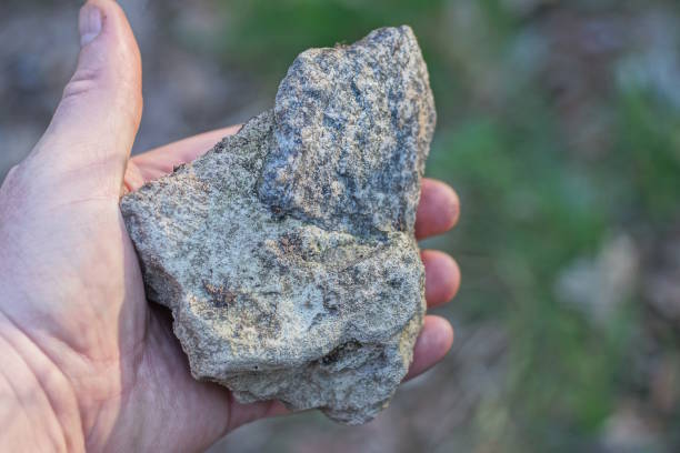 istock a man hand holds a large gray white piece of stone 2148442789