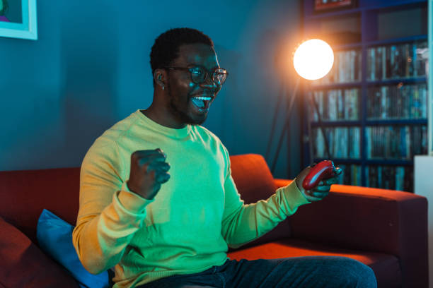 istock Young man playing video games and winning 2148443047