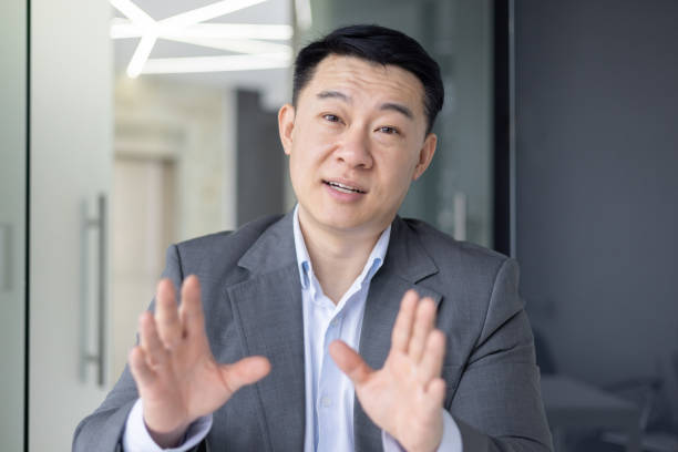 istock Asian businessman making a video call from the office 2148443776