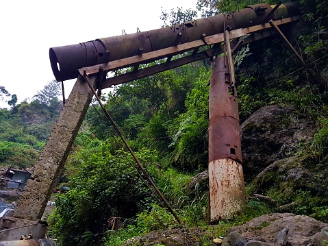 Worn-out ball mills are repurposed as pillars and conduits for mining raw materials in a small-scale mining community in nothern Philippines