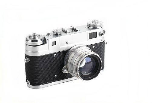 The rare old rangefinder film camera with lens on white background.