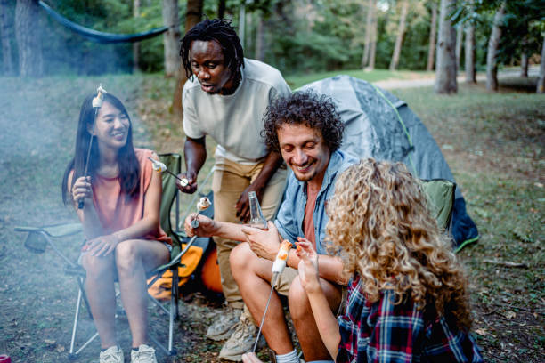 istock Friends enjoying in camping trip while roasting marshmallows 2148445796