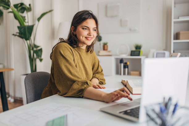 istock Smiling young woman working from home 2148445827