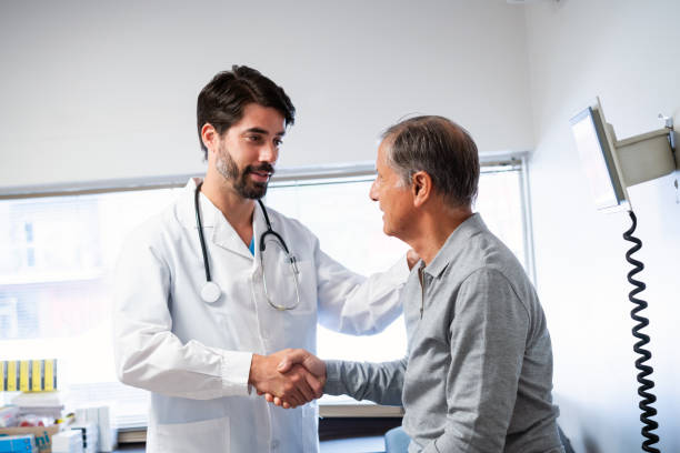 istock Confident Doctor Shaking Hands with Patient in Clinic 2148446366