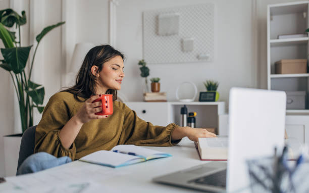 istock Young woman enjoying coffee during work from home 2148446496