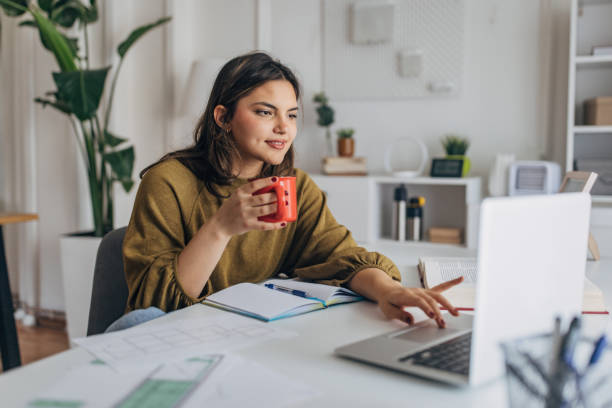 Young woman enjoying coffee during work from home