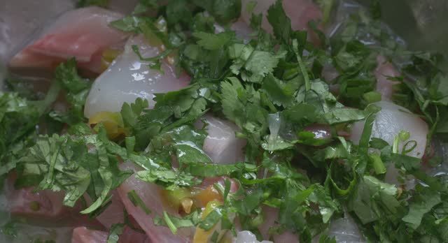 putting coriander on the fish for the ceviche