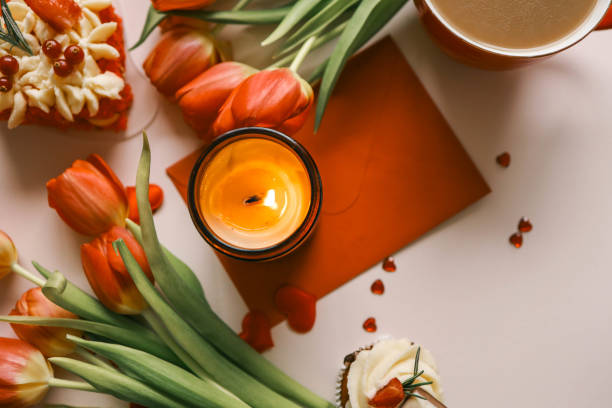 istock Candle and bouquet of red tulips, spring aesthetics 2148448437