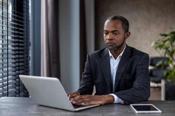istock Professional african american businessman working on laptop in office environment 2148448995