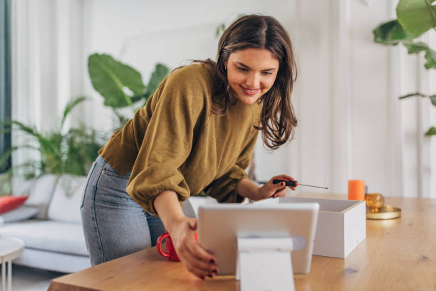 istock Young woman assembling furniture at home 2148449026
