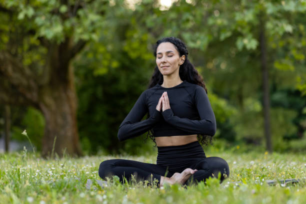 istock Hispanic woman practicing peaceful yoga in a serene park 2148449135