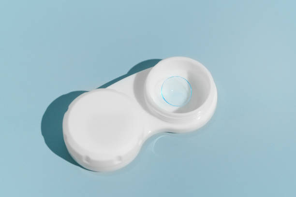 istock Blue soft contact lens for improving eye vision in container on blue isolated background. concept of ophthalmology, eye treatment 2148449193