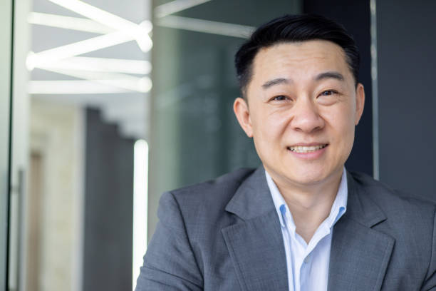 istock Asian businessman in modern office looking confident 2148449832