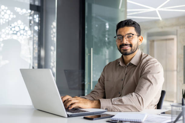 istock Indian businessman working on laptop in modern office 2148450353
