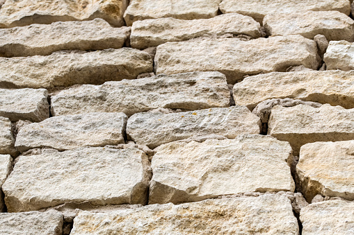 Wall of castle ruins, stone wall texture . \nMedieval castle ruins, old European architecture.