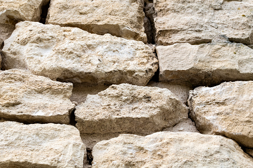 Wall of castle ruins, stone wall texture . \nMedieval castle ruins, old European architecture.