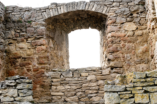 Wall of castle ruins, stone wall texture . \nMedieval castle ruins, old European architecture, ruined window of an old castle made of stone