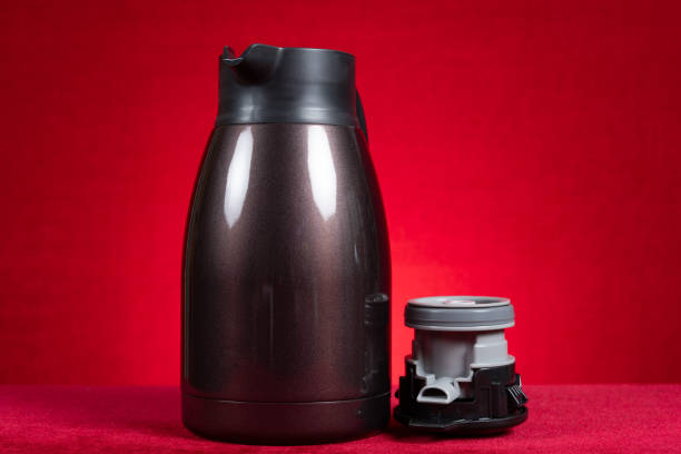 istock a stainless steel thermos bottle with the lid opened on red at horizontal composition 2148451251
