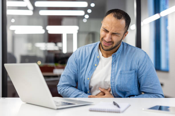 istock Indian businessman feeling unwell at office with laptop 2148451353
