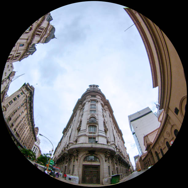Buenos Aires, Argentina. April 24, 2009:\nCaptured with a fisheye lens, the facade of a building in Argentina's capital city takes on a whimsical charm. The distorted perspective adds a playful touch to the architectural details, offering a unique and entertaining view of urban life.