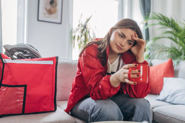 istock Young woman taking a break at home with coffee cup 2148451983