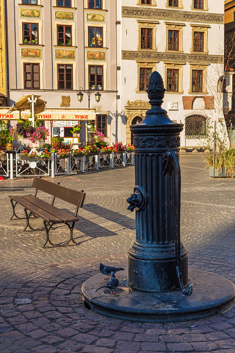 Cityscape - view of an old street standpipe is installed outdoors to dispense water in the Old Town of Warsaw, Poland, 20 August, 2022