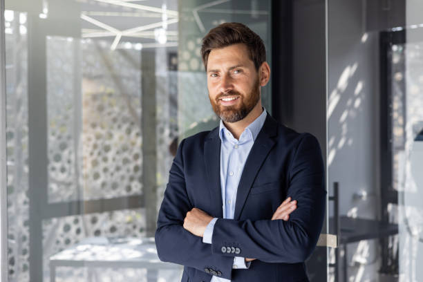 istock Confident smiling businessman in modern office space 2148452793