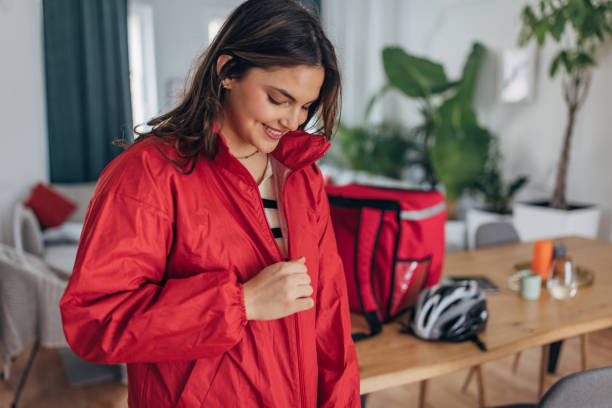 istock Young female delivery rider preparing for work at home 2148452908