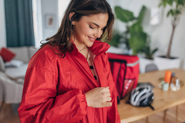 istock Young female delivery rider preparing for work at home 2148452939