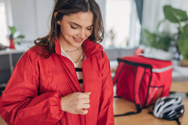 istock Young female delivery rider preparing for work at home 2148452957