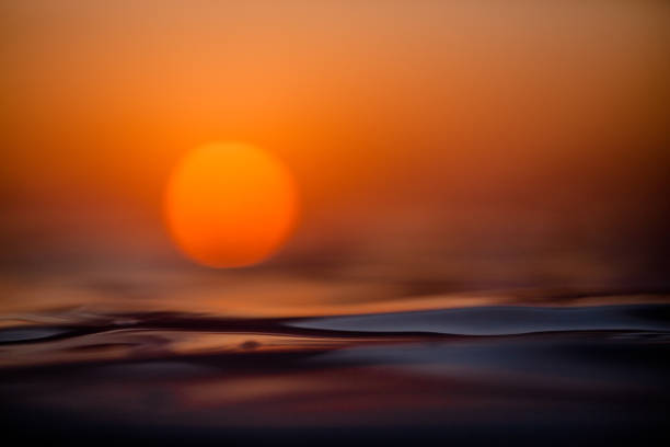 istock Orange sun rising over the ocean 2148453000