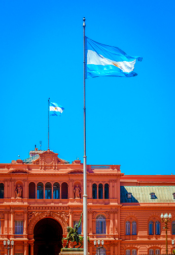 Buenos Aires, Argentina. March 24, 2009. 
In a close-up of Casa Rosada's facade, two Argentine flags wave proudly, epitomizing the nation's political significance. As the executive seat of Argentina, this iconic building symbolizes governance and national pride.