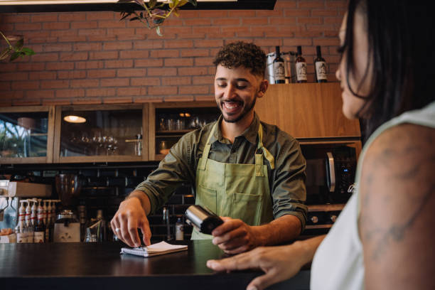 istock Woman making card payment in cafe 2148453820