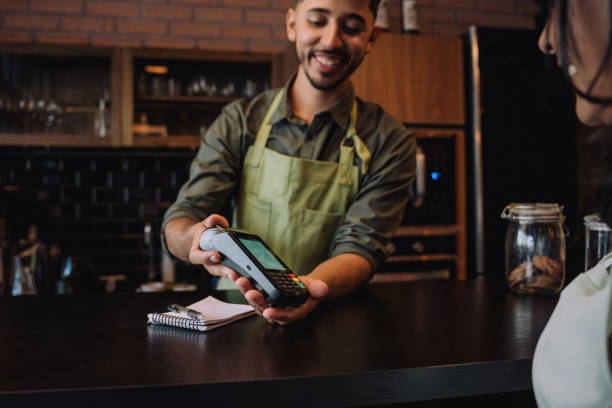 istock Woman making card payment in cafe 2148453824