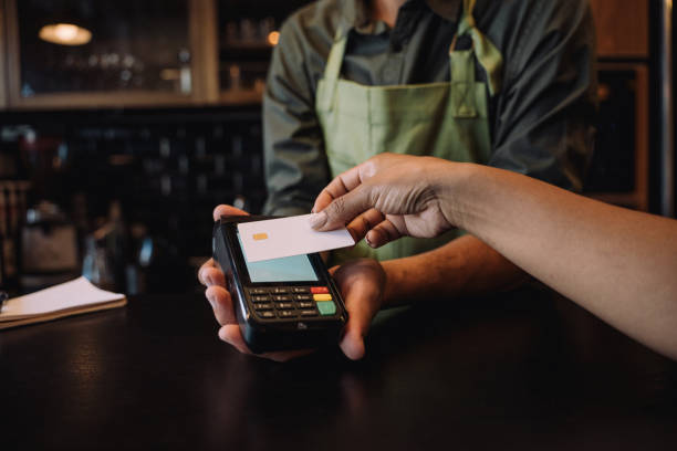 Woman making card payment in cafe