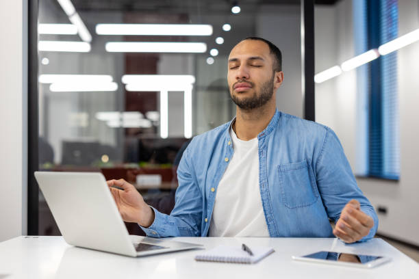istock Relaxed Indian businessman meditating in modern office 2148453899