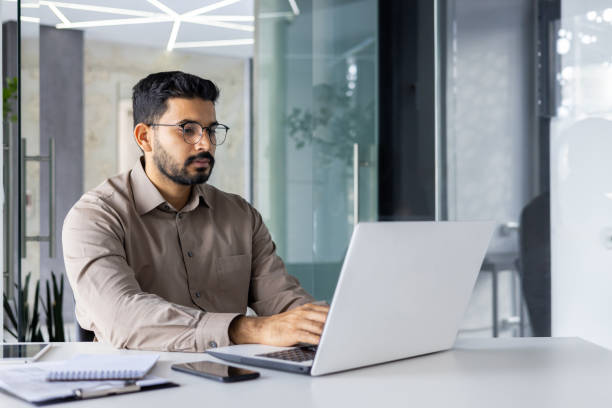 istock Serious Indian businessman working on laptop in office 2148455863