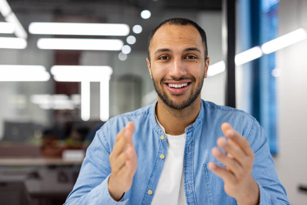 istock Smiling Indian man having video call in modern office 2148456227