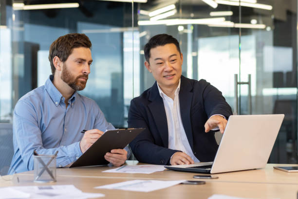 istock Two professional businessmen engaged in a collaborative discussion at a modern office 2148456759